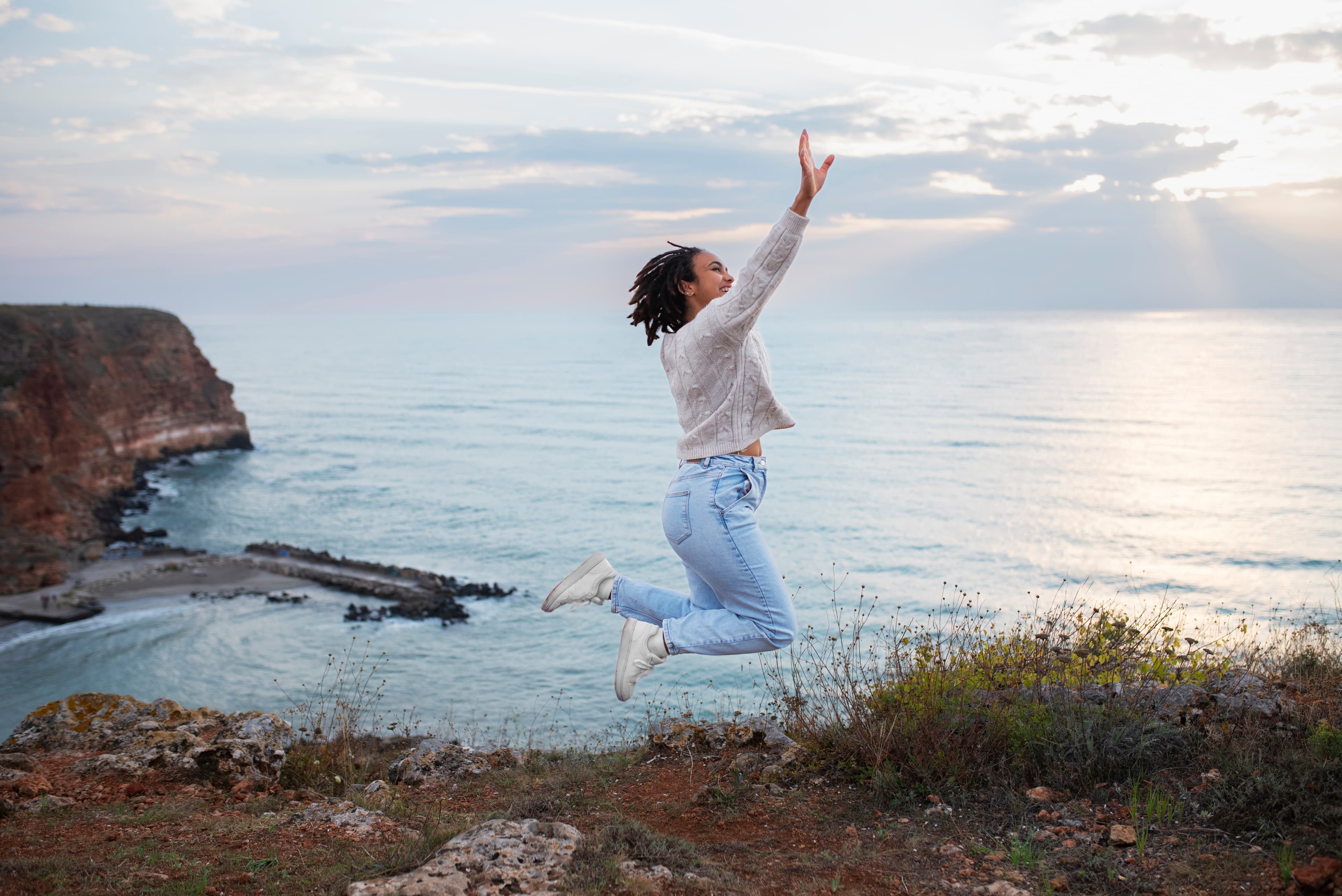 Person jumping with joy near the sea
